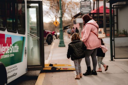 Woman with kids boarding bus. Source: NRTAP photo gallery