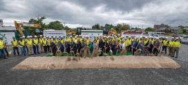 Transit officials, including Transportation Secretary Elaine L. Chao, wield shovels to break ground for the MBTA GLX